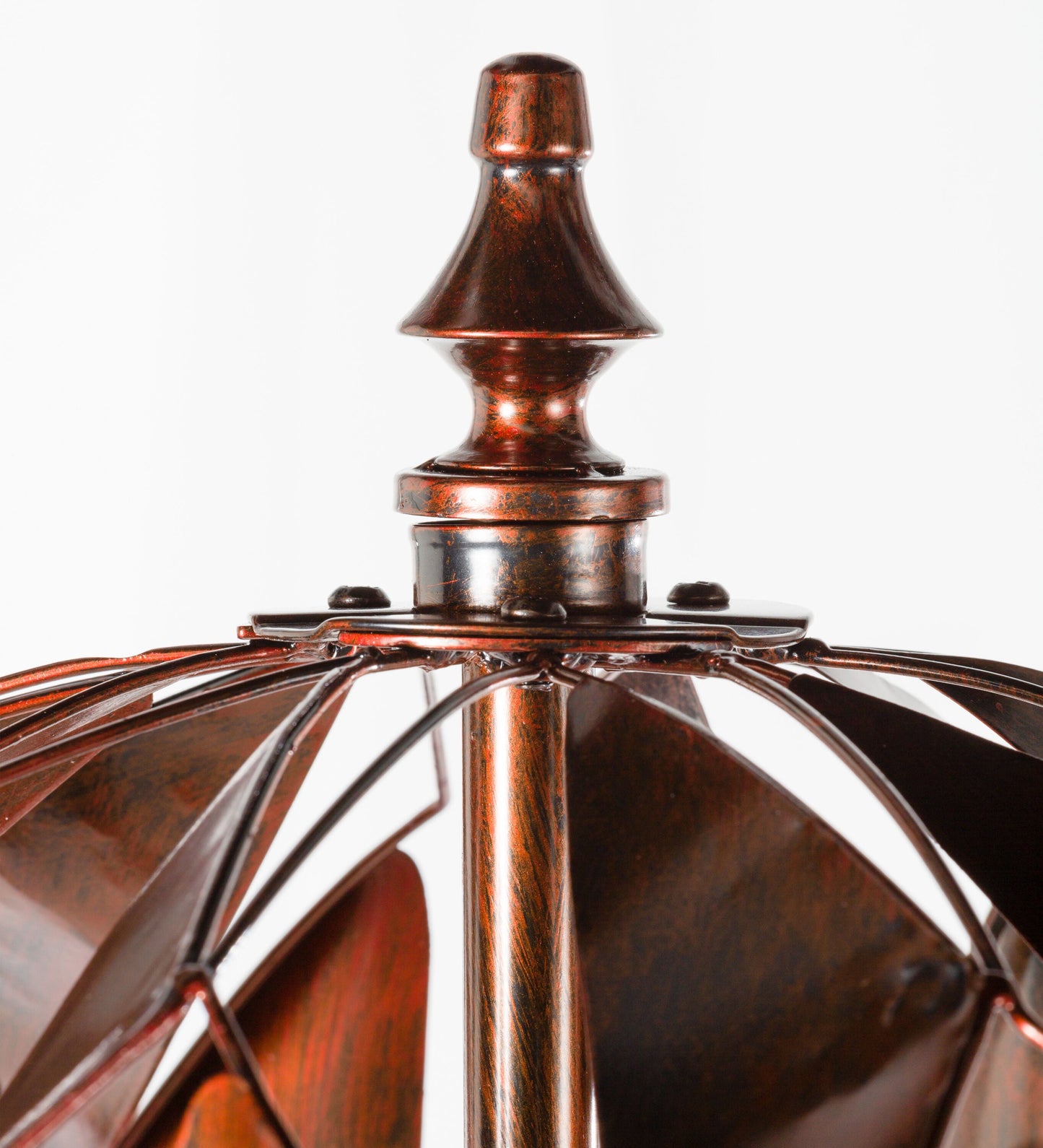 Harlequin Ball Wind Spinner top finial in copper patina with flared collar and radiating blades on Tampa Home & Garden Store