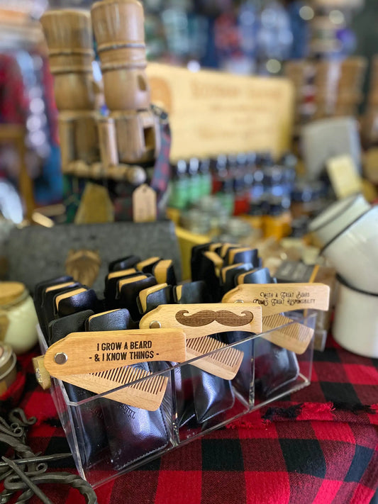 Beard comb laser engraved wooden switchblade with mustache motif in natural wood tones on Tampa Home & Garden Store