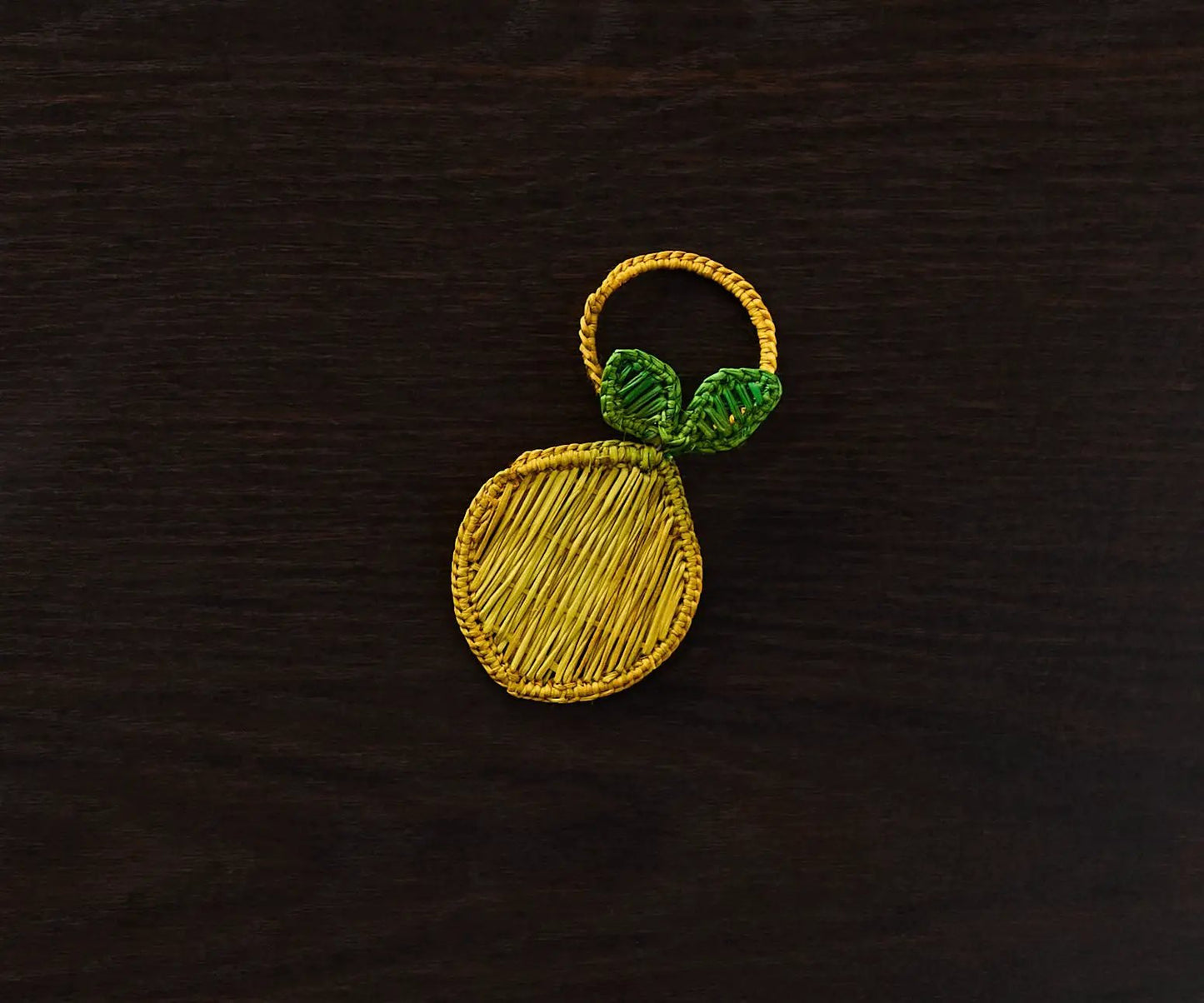 Lemon Napkin Ring Handwoven Iraca Palm, 3.5” diameter with green leaf accent by Payton James on Tampa Home & Garden Store
