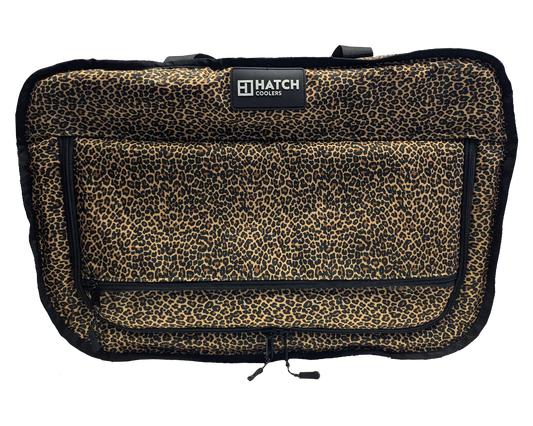 Leopard print canvas cooler 38-can capacity with front zip pocket and Hatch Coolers logo on Tampa Home & Garden Store