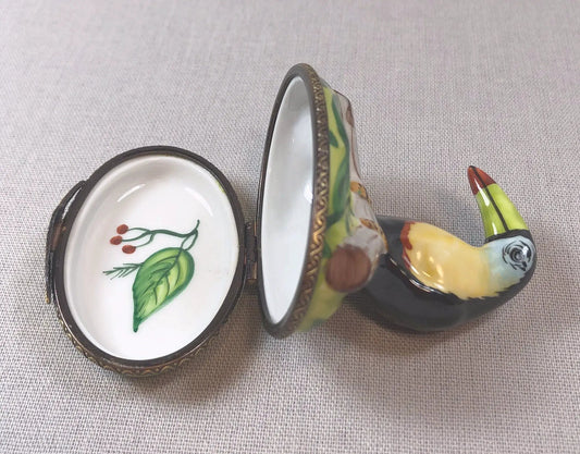 Limoges porcelain bird-on-lid box with brass trim; colorful exterior, white interior on Tampa Home & Garden Store