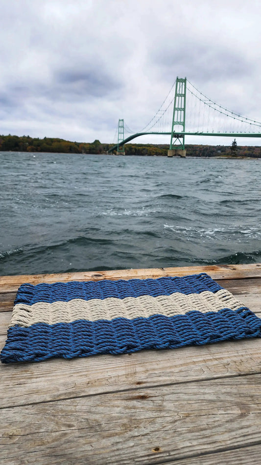 Lobster Rope Mat navy blue and tan by Little Salty Rope on a weathered dock by coastal Maine on Tampa Home & Garden Store