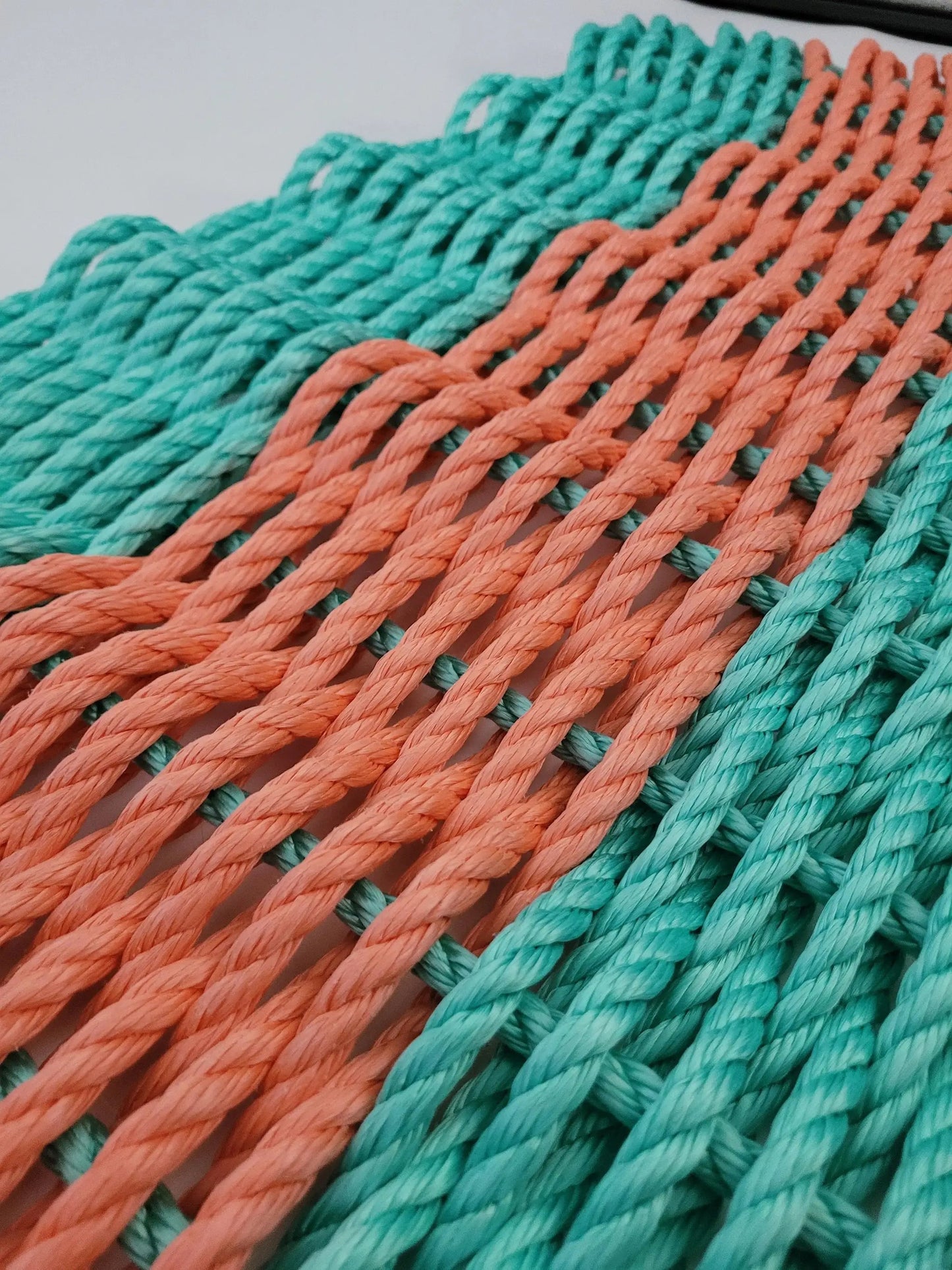 Lobster Rope Mat door mat handmade in teal and coral orange with braided rope texture on Tampa Home & Garden Store