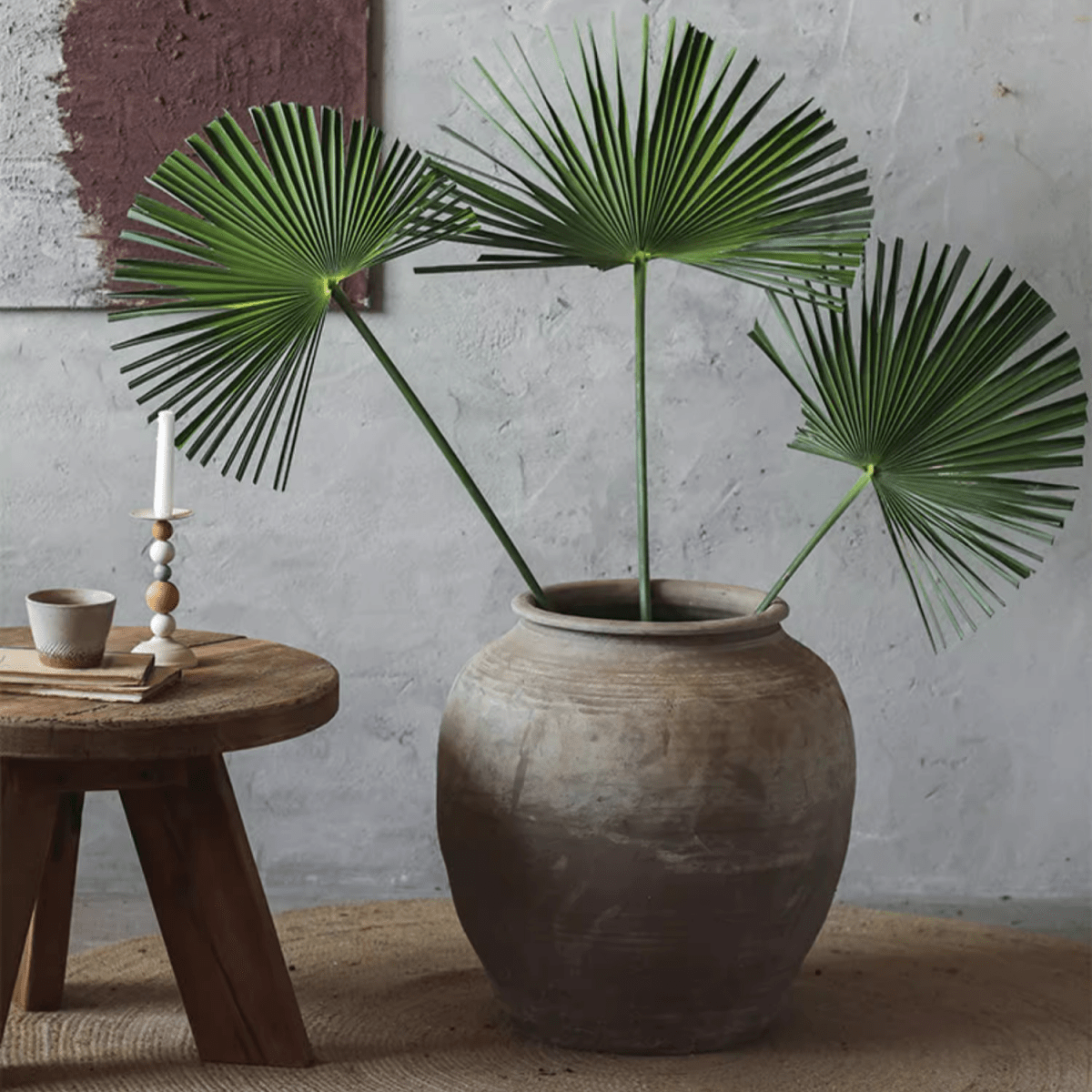 Round Earthenware Pot by RusticReach holding three green fan palm leaves on Tampa Home & Garden Store