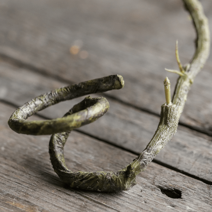RusticReach artificial rattan vine green-brown twisted coils on weathered wood surface 55 inches long on Tampa Home & Garden Store