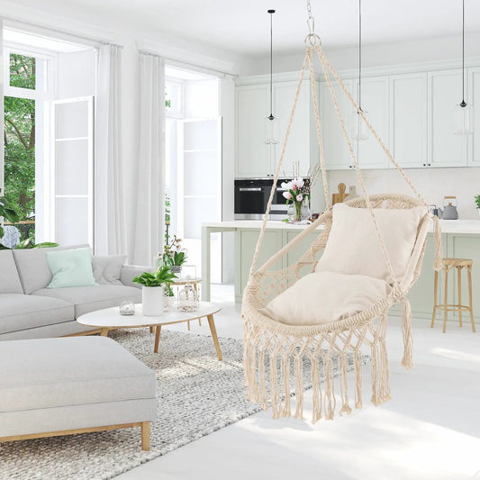 Hanging hammock chair with beige cushions and natural rope in a bright modern living space on Tampa Home & Garden Store