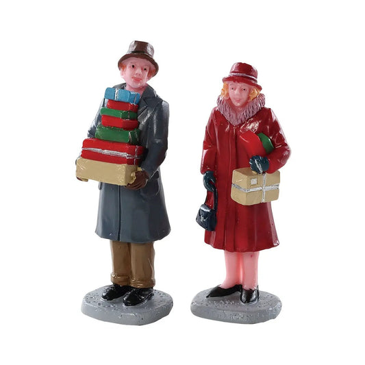 Mailing Frenzy Two Piece Christmas Figurine Set: gray coat man with gifts, red coat woman on Tampa Home & Garden Store