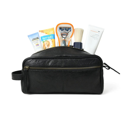 Midnight Deluxe Leather Toiletry Bag for Travel, black leather exterior with 5 items visible on Tampa Home & Garden Store