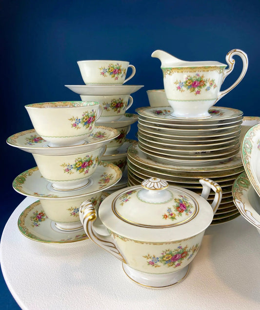 Mikado fine china dinner set with green floral pattern and gold trim, stacked plates and cups on Tampa Home & Garden Store
