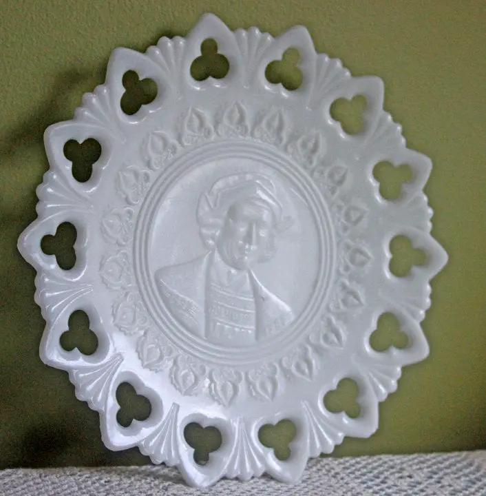 Milk glass plate with a lacy scalloped rim, clover-cutouts, embossed Columbus bust on Tampa Home & Garden Store