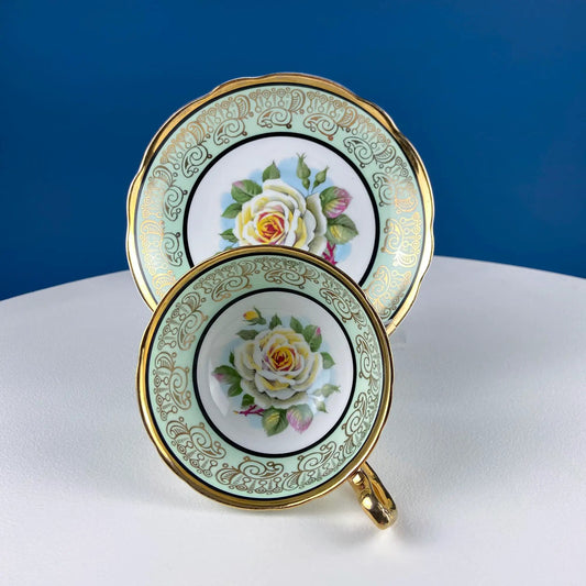 Mint green porcelain cup and saucer set with white rose motif and ornate gold trim on Tampa Home & Garden Store