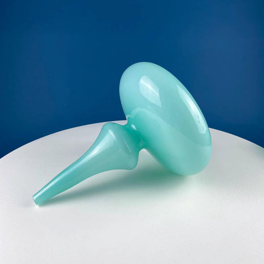 Sky blue hand-blown curvilinear glass vase close-up with smooth translucent surface on a deep blue backdrop on Tampa Home & Garden Store
