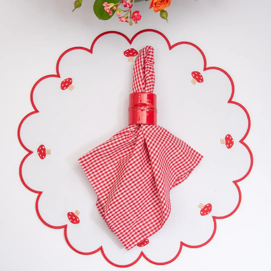 Mushroom placemat with red stitch border and mushroom accents, red gingham napkin centerpiece on Tampa Home & Garden Store