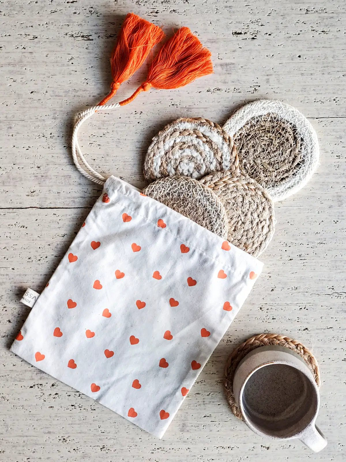 Natural Coaster Gift Set with Heart Pouch: beige coasters and white heart pouch with tassels on Tampa Home & Garden Store