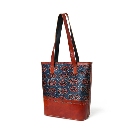 Neela Ajrakh Leather Tote Bag with red leather trim and two red handles on blue paisley fabric on Tampa Home & Garden Store