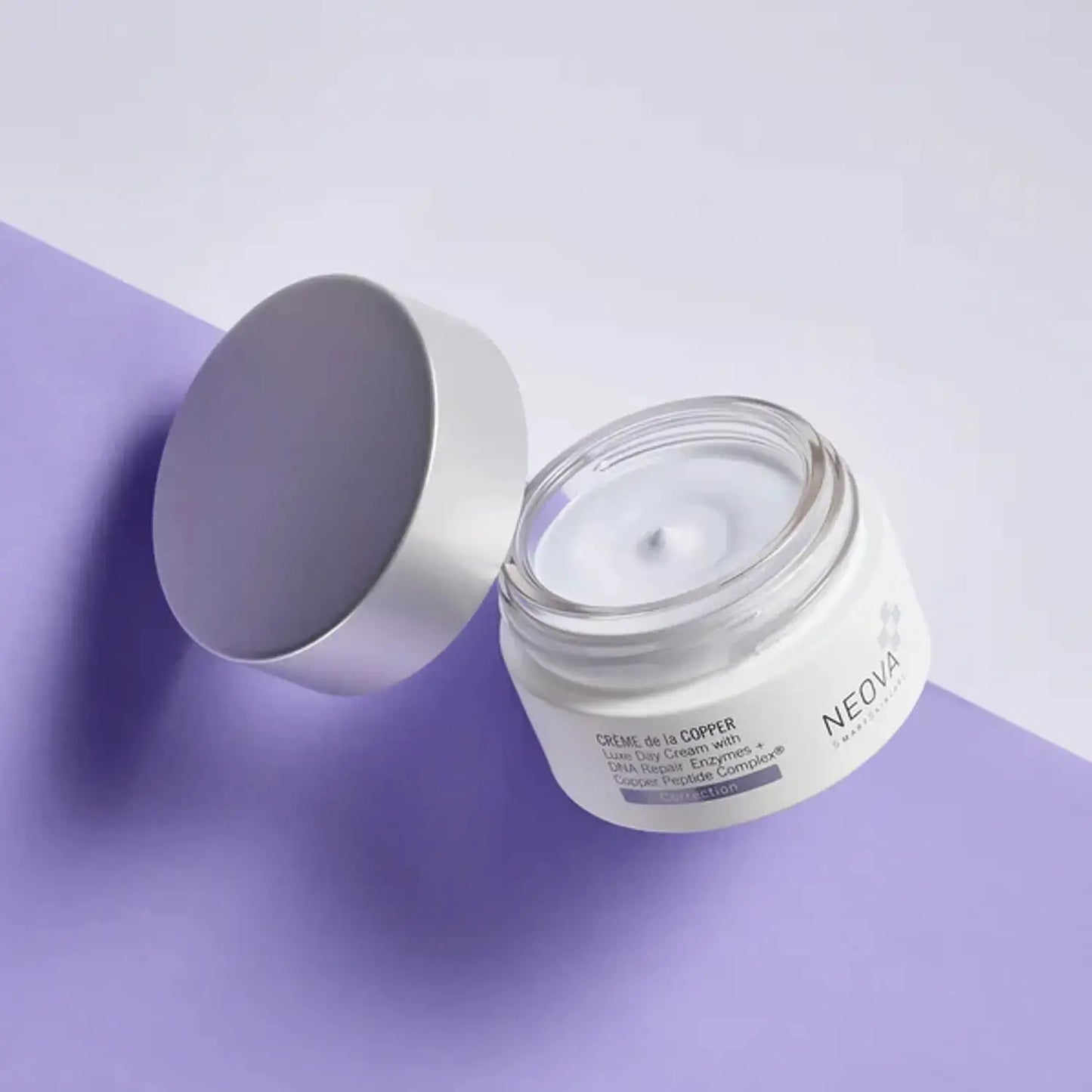 Neova Creme de la Copper 1.7 oz anti-aging skincare jar with silver lid on purple backdrop on Tampa Home & Garden Store