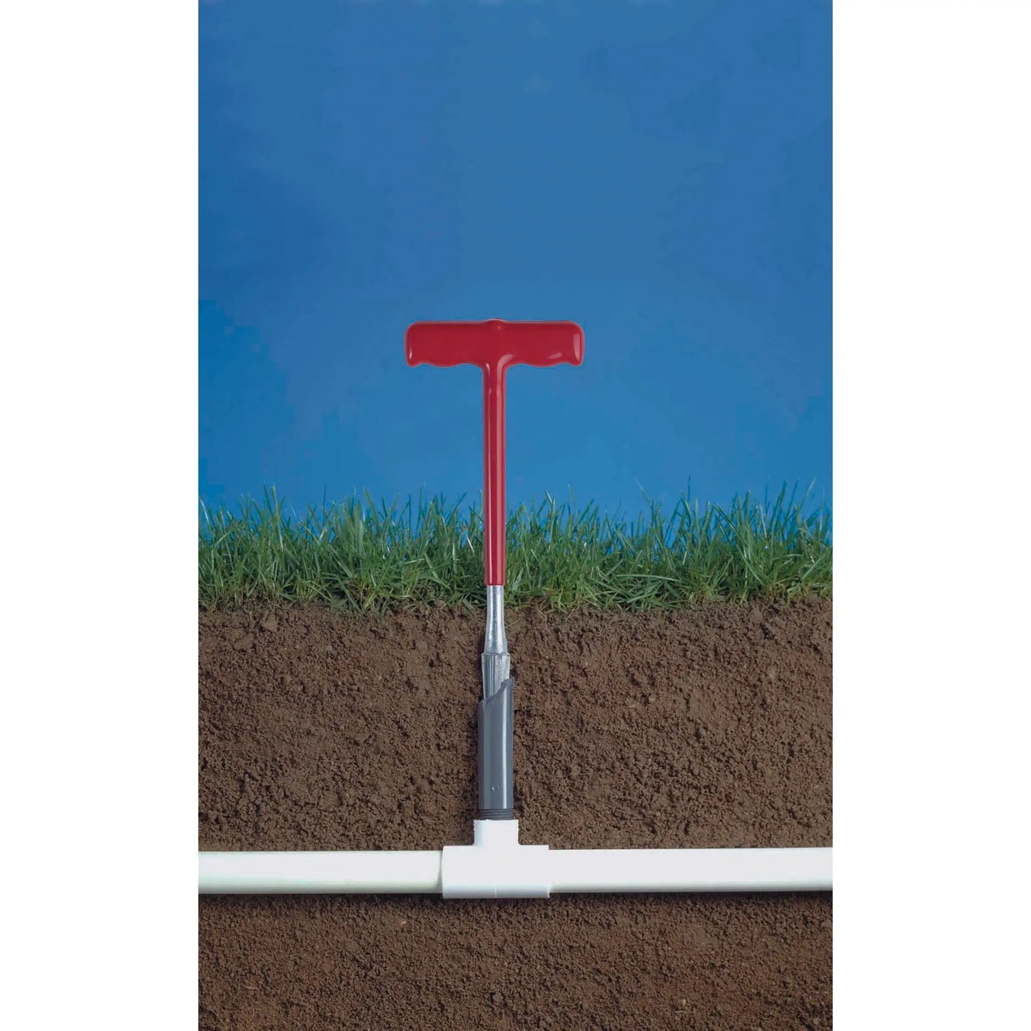 Riser extractor tool by Orbit Irrigation with red handle in soil beside PVC riser on Tampa Home & Garden Store