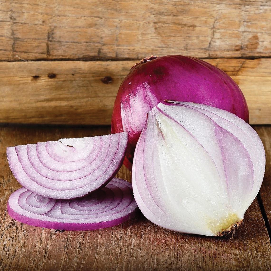 Red Burgundy onion bulbs with purple slices on a rustic wooden board on Tampa Home & Garden Store