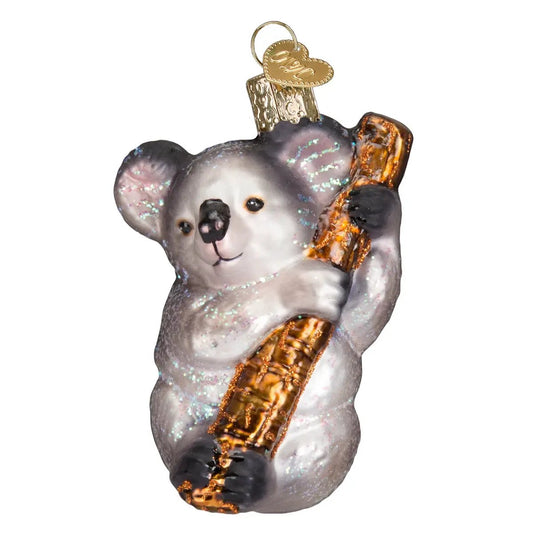 Koala bear ornament glass with gray glitter finish holding a gold log on Tampa Home & Garden Store