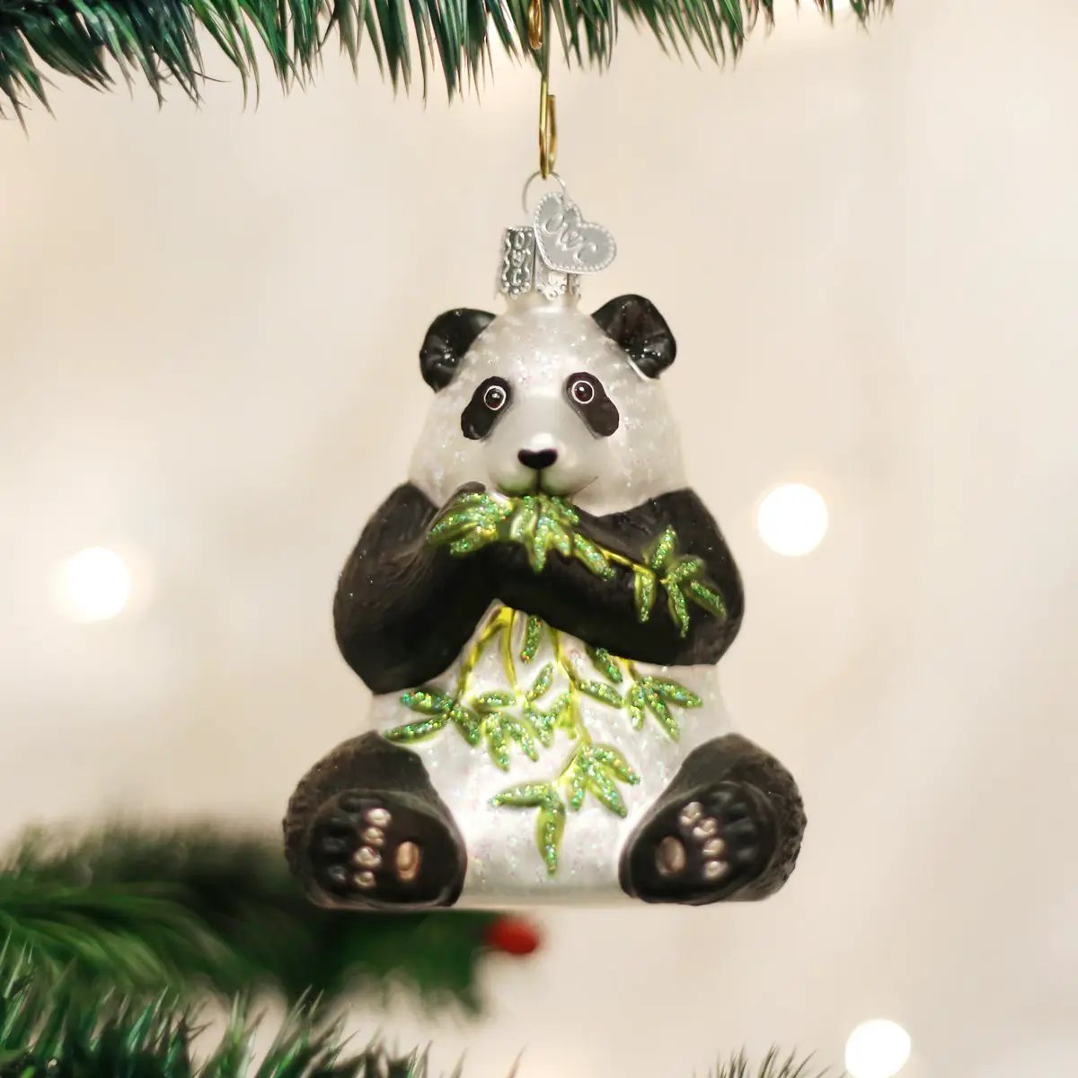 Old World Christmas panda ornament keepsake, black and white panda with glittery green bamboo accents on Tampa Home & Garden Store