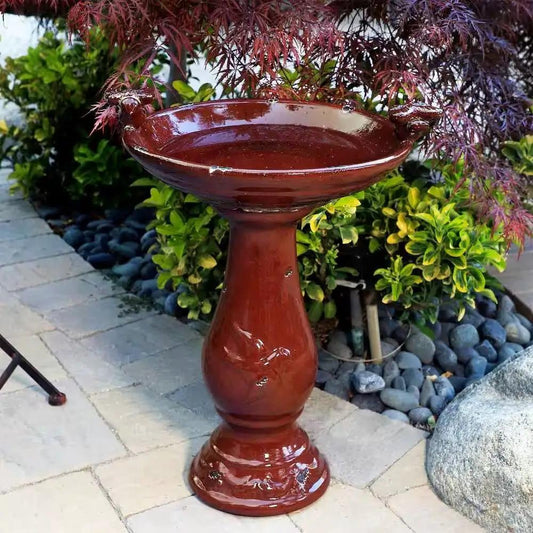 Outdoor dark red ceramic birdbath with a glossy antique finish on pedestal stand on Tampa Home & Garden Store