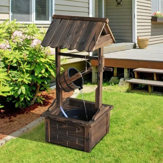 Outdoor solid wood wishing well fountain with bucket and flowing water in a backyard garden on Tampa Home & Garden Store