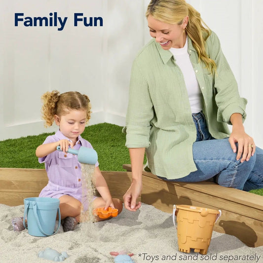 Outdoor Kid's Octagonal Sandbox in wood finish with blue bucket and sand toys on Tampa Home & Garden Store
