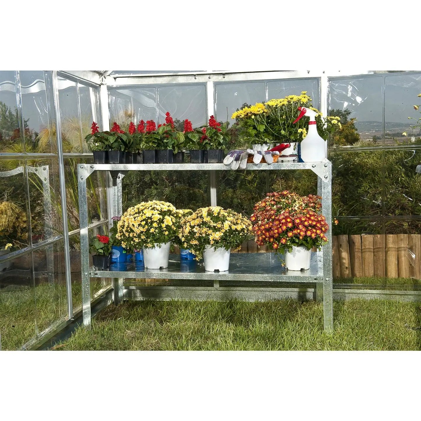 Outdoor metal potting bench in steel with red pots on top and chrysanthemums bottom on Tampa Home & Garden Store
