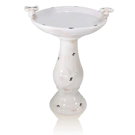 Off-white ceramic birdbath with pedestal base, light-brown finish and bird-figures on rim on Tampa Home & Garden Store