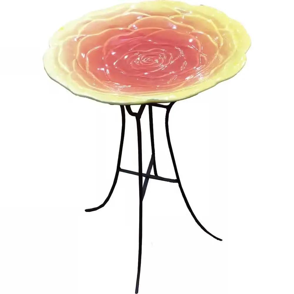 Ceramic floral birdbath with yellow-pink bloom on black metal stand on Tampa Home & Garden Store