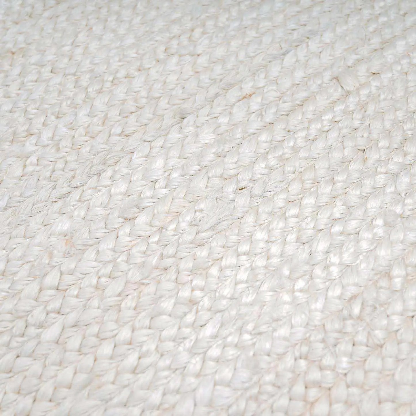 Pangnir handwoven braided jute rug in cream color, close-up of woven texture on Tampa Home & Garden Store