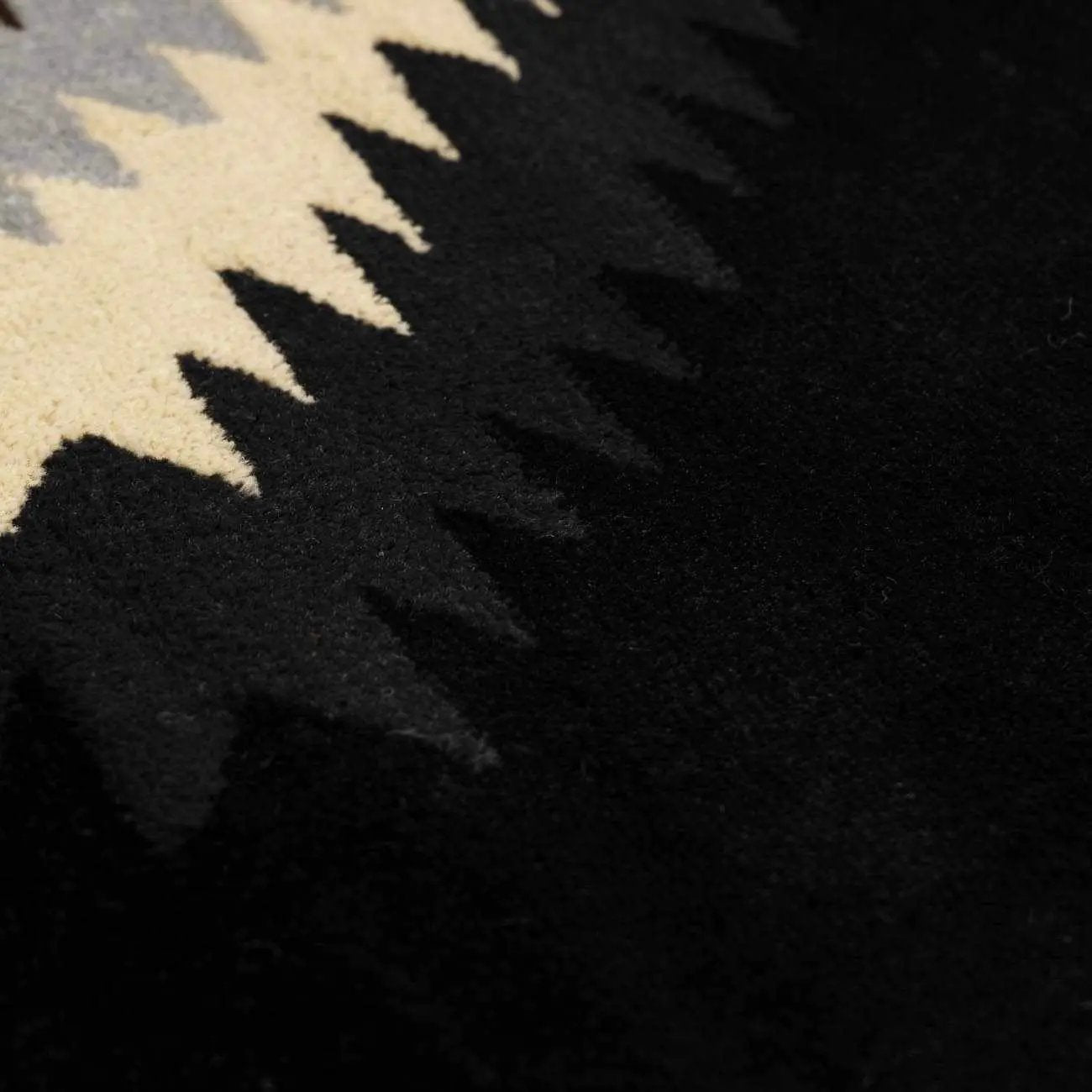 Buckhaven Black Southwestern Area Rug close-up of black pile with beige zigzag motif Boutique Rugs on Tampa Home & Garden Store