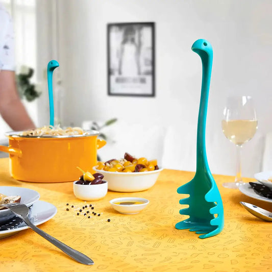 Ototo Nessie pasta spoons turquoise slotted, 2 pcs on table beside orange pot on Tampa Home & Garden Store