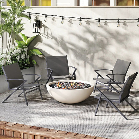 Four patio chairs with grey metal frames and mesh seats around a round white fire pit on Tampa Home & Garden Store