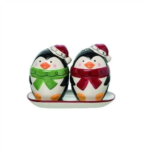 Penguin shaker pair on dish; dolomite decor with hats and green/red scarves on Tampa Home & Garden Store