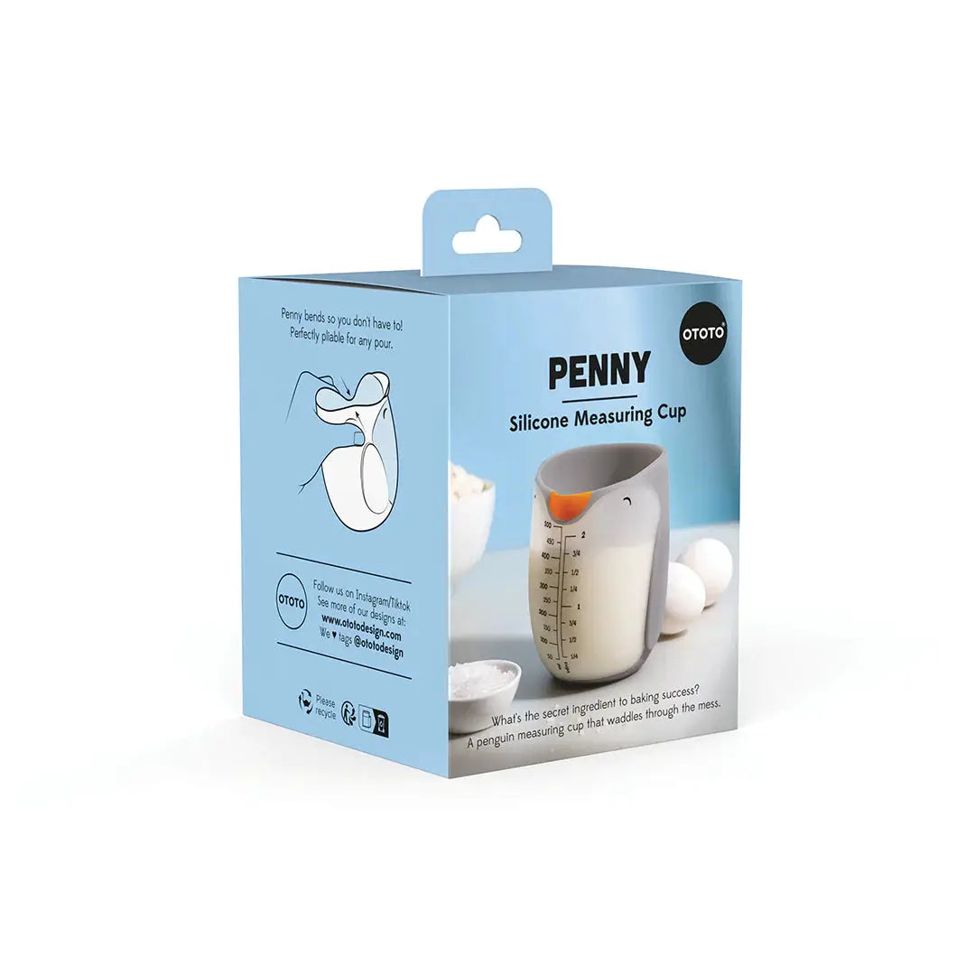 Penny silicone measuring cup by OTOTO DESIGN in blue packaging; white cup with orange pour spout on Tampa Home & Garden Store