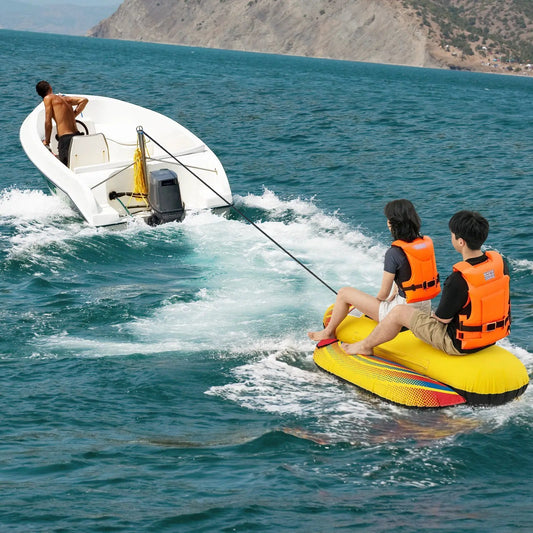 White inflatable banana boat towable for one or two riders being towed by a boat on blue water on Tampa Home & Garden Store