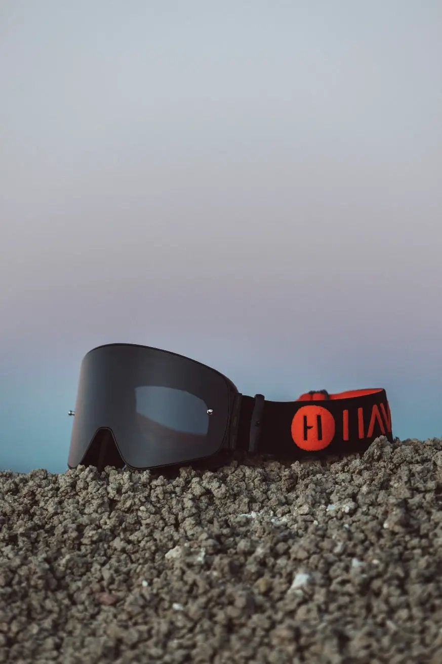 Phantom Havoc Infinity goggle with dark lens, black strap, orange Havoc logo on ground on Tampa Home & Garden Store