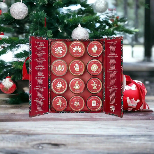Advent Candle Set by Gia Roma, 12 red tins with festive icons in a holiday gift box on Tampa Home & Garden Store