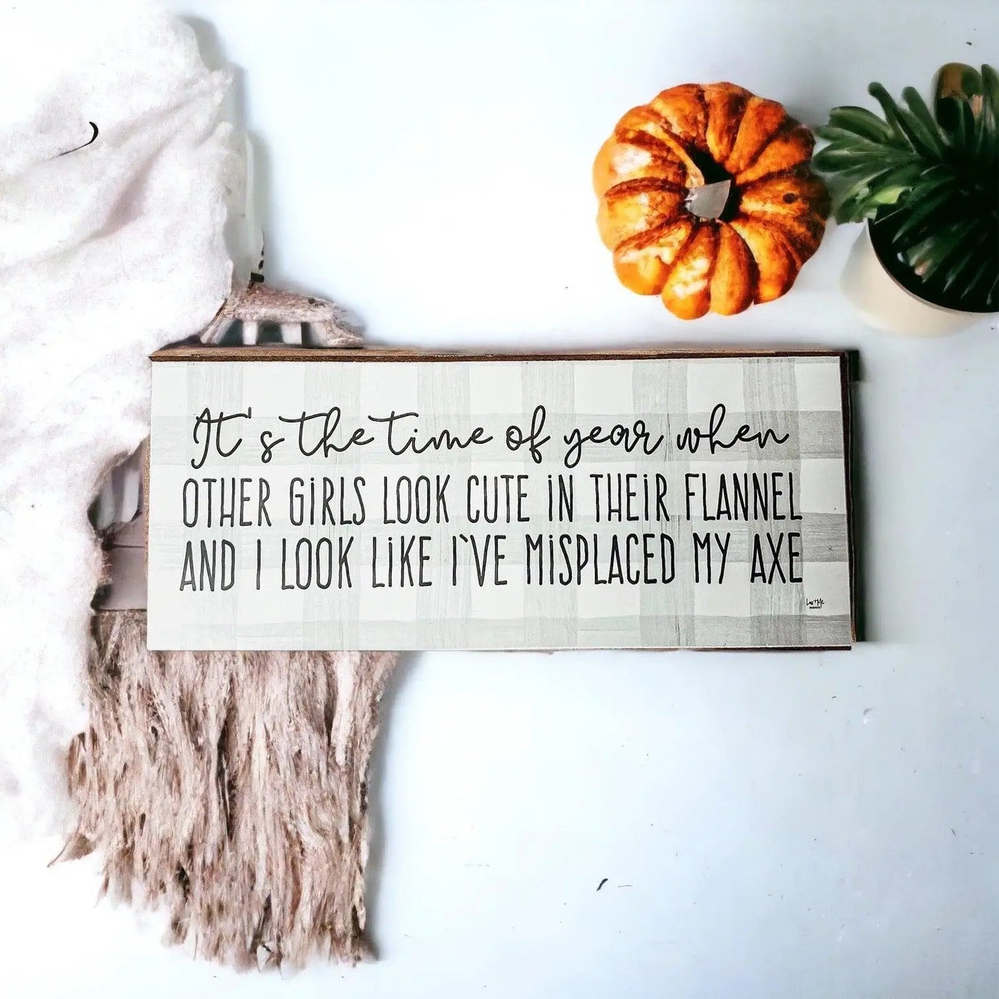 Misplaced Axe Sign for Fall and Winter by Gia Roma, gray striped wood sign with black text on Tampa Home & Garden Store