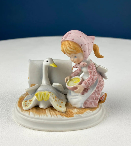 Lefton porcelain girl feeding goose figurine with pink bonnet and dress on ivory base on Tampa Home & Garden Store