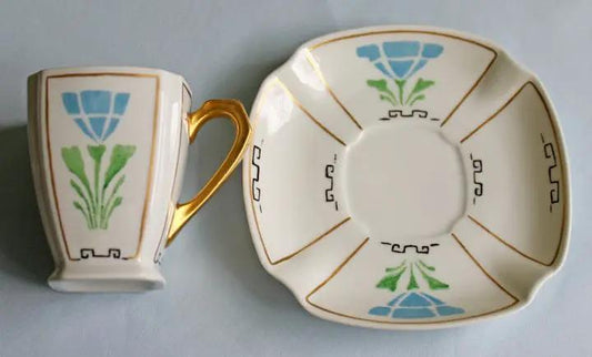 Porcelain demitasse cup and saucer set with blue-green floral motif and gold handle on Tampa Home & Garden Store