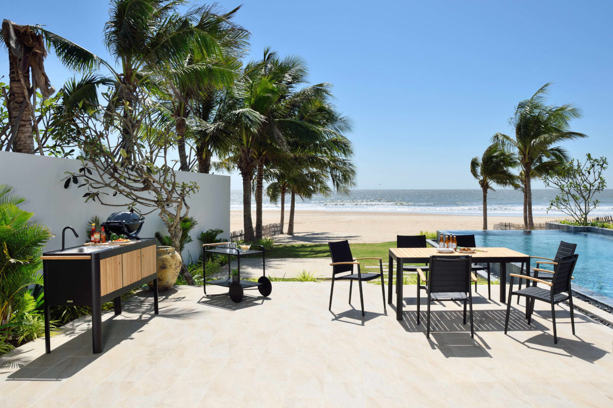 Portals Dark Outdoor Kitchen on a beachfront patio with a black-framed island on Tampa Home & Garden Store