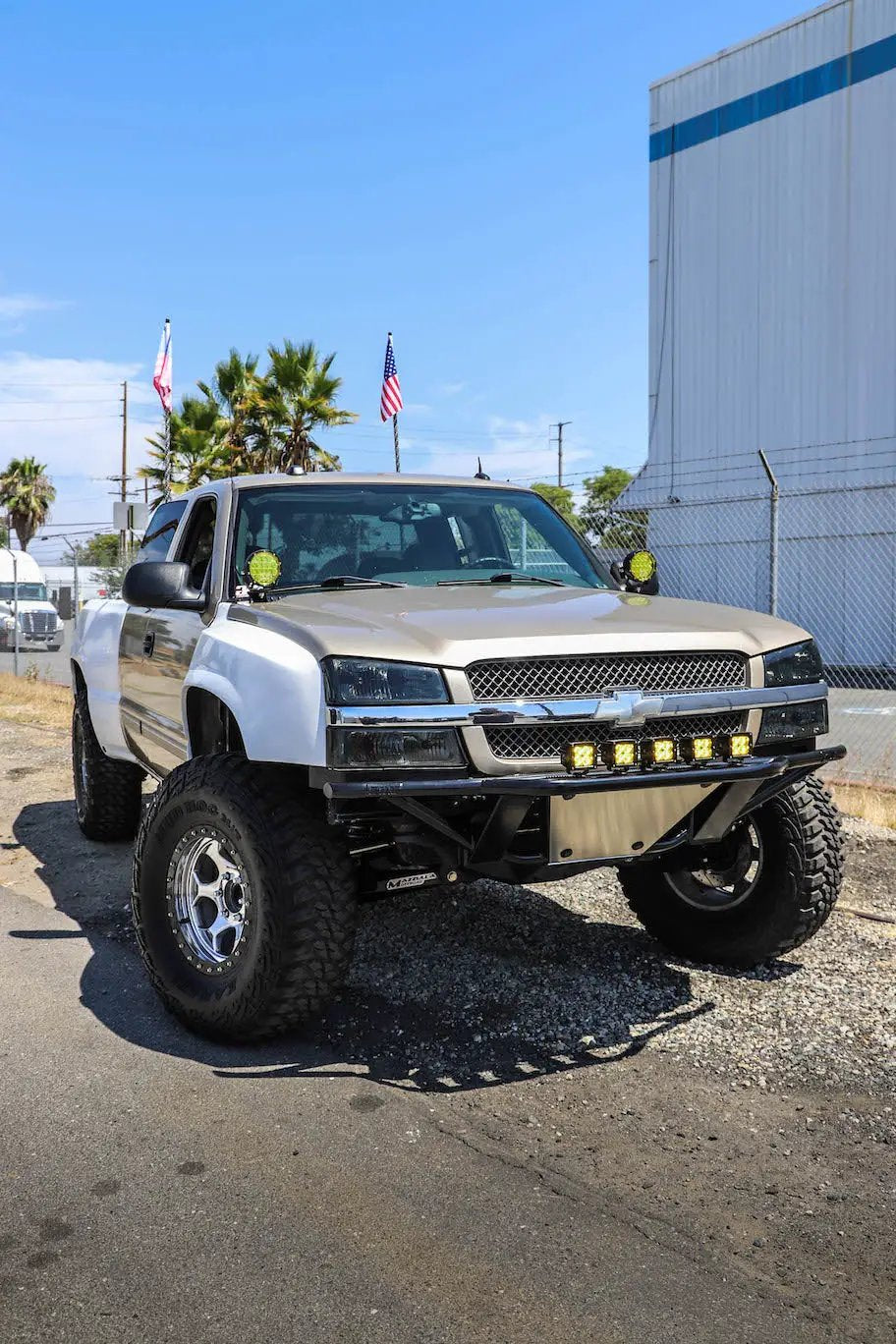Chevy Silverado hood pillar mounts for LED pods by GGLighting on beige two-tone lifted truck on Tampa Home & Garden Store
