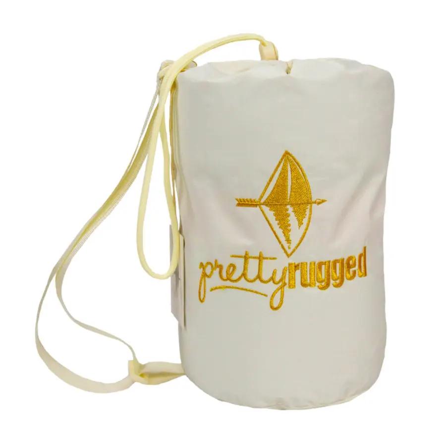 Luxurious baby blanket with waterproof backing in white bag with yellow Pretty Rugged embroidery on Tampa Home & Garden Store