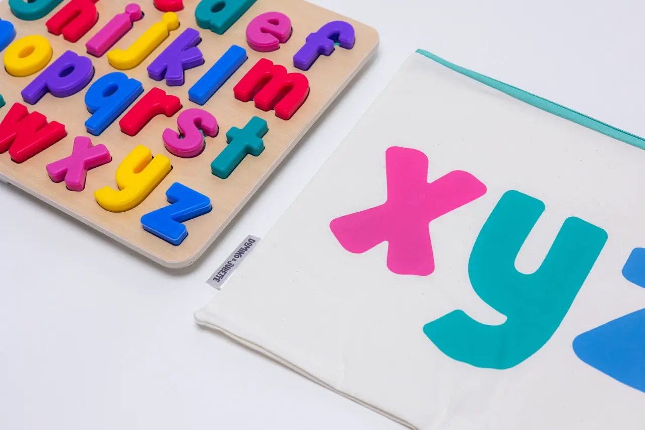 xyz Find & Fit Puzzle by Domino & Juliette with colorful 3D letter pieces on a wooden board on Tampa Home & Garden Store