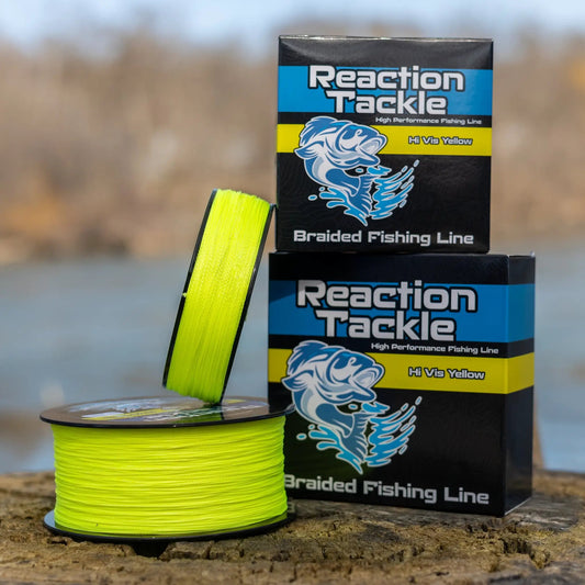 Reaction Tackle braided fishing line Hi-Vis Yellow spool beside two stacked boxes on Tampa Home & Garden Store