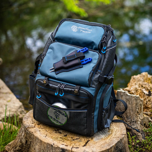 Reaction Tackle saltwater fishing backpack in blue with mesh pockets and blue zipper pulls on Tampa Home & Garden Store