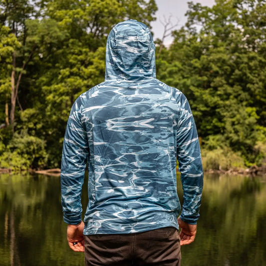 Reaction Tackle SPF 50+ long sleeve hooded fishing shirt in blue camouflage, back view on Tampa Home & Garden Store