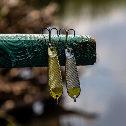Reaction Tackle tungsten jigging spoons 2-pack gold and silver with hooks on green surface on Tampa Home & Garden Store